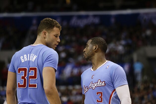 Los Angeles Clippers's Blake Griffin, left, talks with Chris Paul during the first half of an NBA basketball game against the Cleveland Cavaliers on Sunday, March 16, 2014, in Los Angeles. (AP Photo/Jae C. Hong)