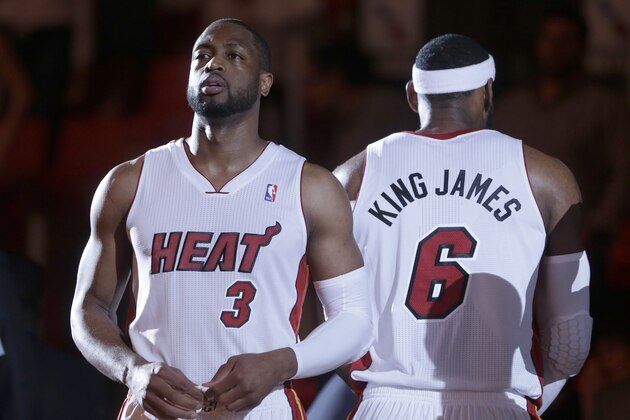 Miami Heat guard Dwyane Wade (3) and forward LeBron James (6) stand during player introductions before the start of an NBA basketball game against the Brooklyn Nets, Wednesday, March 12, 2014 in Miami. (AP Photo/Wilfredo Lee)