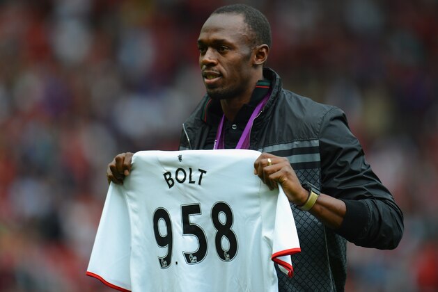 MANCHESTER, ENGLAND - AUGUST 25:  Jamaican Athlete Usain Bolt poses with a United shirt prior to the Barclays Premier League match between Manchester United and Fulham at Old Trafford on August 25, 2012 in Manchester, England.  (Photo by Shaun Botterill/Getty Images)