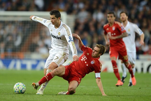 MADRID, SPAIN - APRIL 25:  Philipp Lahm of Bayern Munich tackles Cristiano Ronaldo of Real Madrid during the UEFA Champions League Semi Final second leg between Real Madrid CF and Bayern Munich at The Bernabeu Stadium on April 25, 2012 in Madrid, Spain.  (Photo by Jasper Juinen/Getty Images)