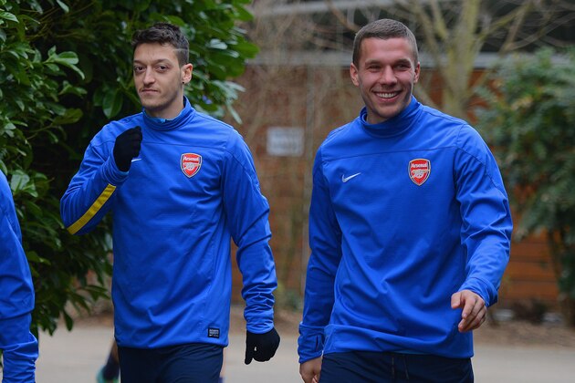 ST ALBANS, ENGLAND - MARCH 10:  Mesut Ozil and Lukas Podolski walk out during the Arsenal training session at London Colney on March 10, 2014 in St Albans, England.  (Photo by Michael Regan/Getty Images)
