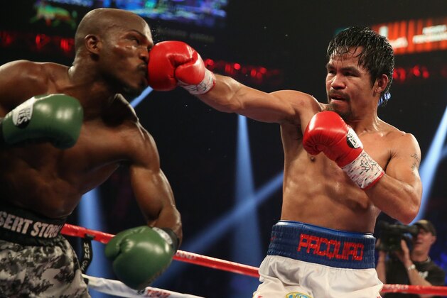 LAS VEGAS, NV - APRIL 12:  Manny Pacquiao throws a right hand at Timothy Bradley at the MGM Grand Garden Arena on April 12, 2014 in Las Vegas, Nevada.  (Photo by Jeff Gross/Getty Images)