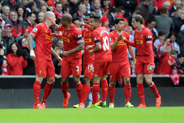 Liverpool's Martin Skrtel left, celebrates with his team-mates after he scores the second goal of the game for his side during their English Premier League soccer match against Manchester City at Anfield in Liverpool, England, Sunday April. 13, 2014. (AP Photo/Clint Hughes)