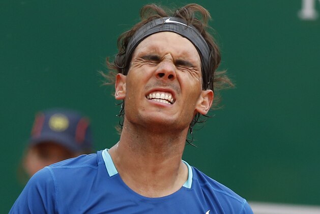 Rafael Nadal of Spain reacts after loosing a point against David Ferrer of Spain during their quarterfinals match of the Monte Carlo Tennis Masters tournament in Monaco, Friday, April 18, 2014. Ferrer won 7-6 6-4. (AP Photo/Michel Euler)