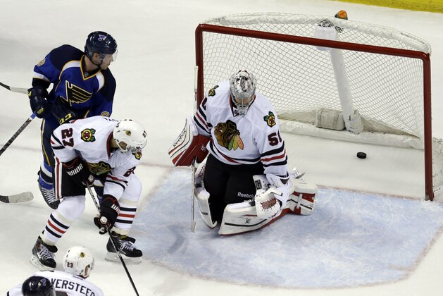 St. Louis Blues' Jaden Schwartz, top left, watches as his shot slips past Chicago Blackhawks goalie Corey Crawford and Johnny Oduya (27), of Sweden, for a goal during the third period in Game 1 of a first-round NHL hockey Stanley Cup playoff series Thursday, April 17, 2014, in St. Louis. (AP Photo/Jeff Roberson)