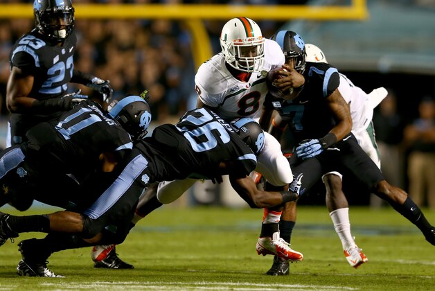 CHAPEL HILL, NC - OCTOBER 17:  Dominique Green #26 of the North Carolina Tar Heels tackles Duke Johnson #8 of the Miami Hurricanes during their game at Kenan Stadium on October 17, 2013 in Chapel Hill, North Carolina.  (Photo by Streeter Lecka/Getty Images)