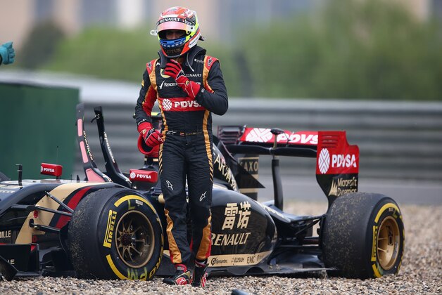 SHANGHAI, CHINA - APRIL 18:  Pastor Maldonado of Venezuela and Lotus walks away from his car after crashing off the track during practice ahead of the Chinese Formula One Grand Prix at the Shanghai International Circuit on April 18, 2014 in Shanghai, China.  (Photo by Clive Mason/Getty Images)