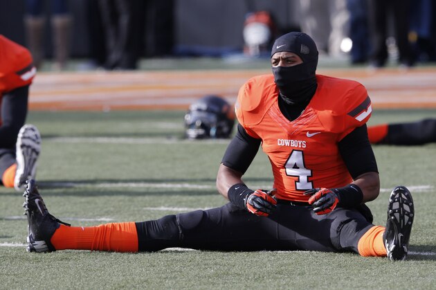 Oklahoma State cornerback Justin Gilbert (4) stretches before the start of an NCAA college football game between Oklahoma State and Oklahoma in Stillwater, Okla., Saturday, Dec. 7, 2013. (AP Photo/Sue Ogrocki) Oklahoma State cornerback Justin Gilbert (4) stretches before the start of an NCAA college football game between Oklahoma State and Oklahoma in Stillwater, Okla., Saturday, Dec. 7, 2013. (AP Photo/Sue Ogrocki)