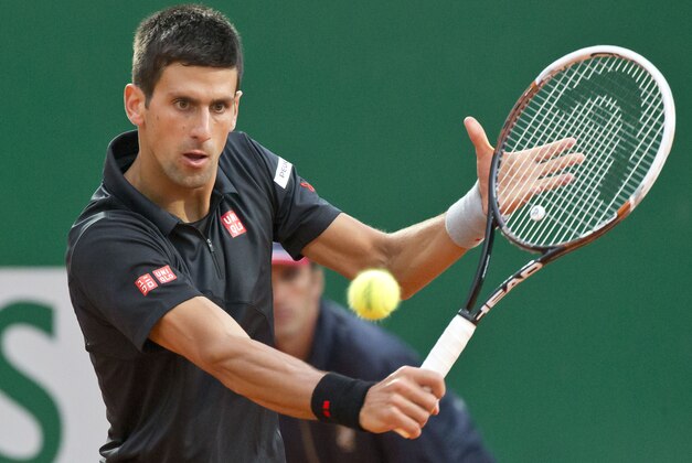 Novak Djokovic of Serbia, returns the ball to Guillermo Garcia-Lopez of Spain during their quarterfinals match of the Monte Carlo Tennis Masters tournament in Monaco, Friday, April 18, 2014. (AP Photo/Michel Euler)