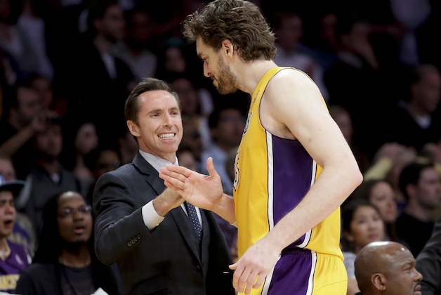 Los Angeles Lakers' Pau Gasol, of Spain, is greeted by Steve Nash during overtime of an NBA basketball game against the Houston Rockets in Los Angeles, Wednesday, April 17, 2013. The Lakers won 99-95. (AP Photo/Jae C. Hong)