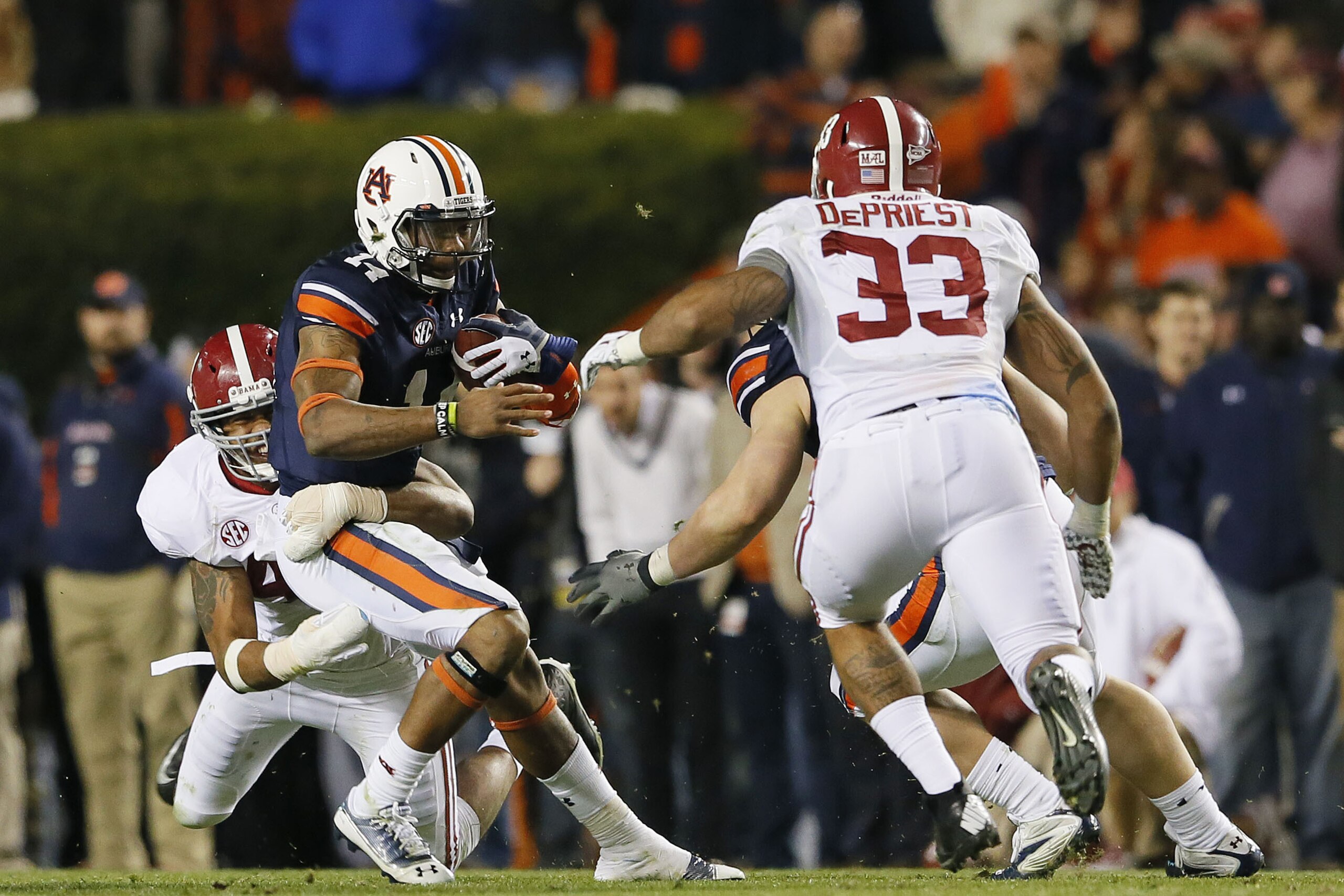 AUBURN, AL - NOVEMBER 30:  Nick Marshall #14 of the Auburn Tigers is tackled by Adrian Hubbard #42 of the Alabama Crimson Tide in the fourth quarter at Jordan-Hare Stadium on November 30, 2013 in Auburn, Alabama.  (Photo by Kevin C. Cox/Getty Images)