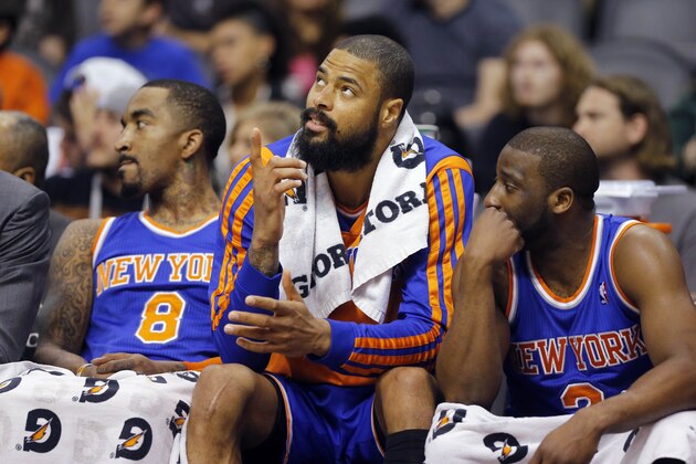 New York Knicks' J.R. Smith, Tyson Chandler and Raymond Felton, from left, watch the final minute against the Phoenix Suns form the bench during an NBA basketball game, Friday, March 28, 2014, in Phoenix. The Suns won 112-88. (AP Photo/Matt York)