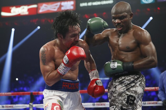Manny Pacquiao, left, of the Philippines, trades punches with Timothy Bradley, in their WBO welterweight title boxing fight Saturday, April 12, 2014, in Las Vegas. (AP Photo/Isaac Brekken)
