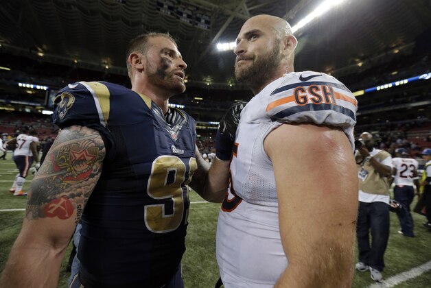 St. Louis Rams defensive end Chris Long, left, talks to his brother Chicago Bears guard Kyle Long following an NFL football game on Sunday, Nov. 24, 2013, in St. Louis. The Rams won 42-21. (AP Photo/Nam Y. Huh)