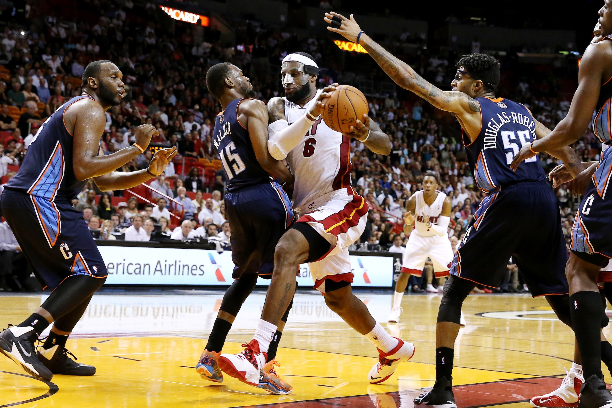Mar 3, 2014; Miami, FL, USA; Miami Heat small forward LeBron James (6) drives to the basket between Charlotte Bobcats point guard Kemba Walker (15) and  shooting guard Chris Douglas-Roberts (55)  in the second half at American Airlines Arena. The Heat won 124-107. Mandatory Credit: Robert Mayer-USA TODAY Sports