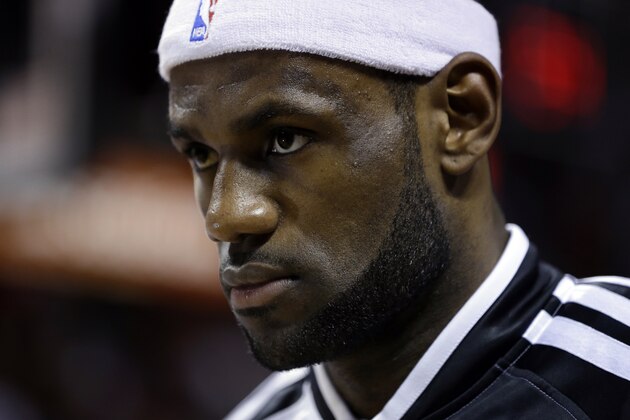 Miami Heat's LeBron James stands for the national anthem before an NBA basketball game against the Indiana Pacers, Friday, April 11, 2014, in Miami. (AP Photo/Lynne Sladky)