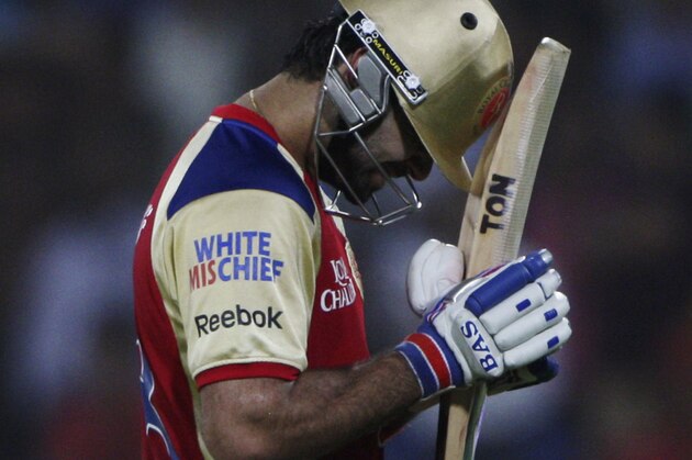 Royal Challengers Bangalore's Virat Kohli walks towards the pavilion after he was dismissed by Deccan Chargers bowler Ashish Reddy during their Indian Premier League (IPL) cricket match in Hyderabad, India, Sunday, May 20, 2012. (AP Photo/Mahesh Kumar A.)