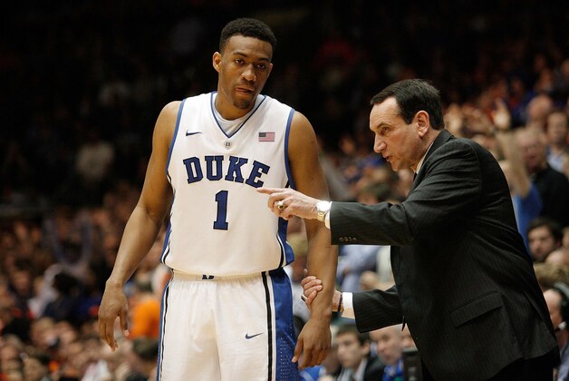 Feb 22, 2014; Durham, NC, USA; Duke Blue Devils head coach Mike Krzyzewski talks to forward Jabari Parker (1) on the sidelines against the Syracuse Orange at Cameron Indoor Stadium. Mandatory Credit: Mark Dolejs-USA TODAY Sports