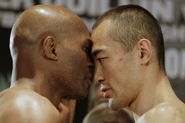 IBF light heavyweight boxing champion Bernard Hopkins, left, faces off with WBA and IBA light heavyweight boxing champion Beibut Shumenov, of Kazakhstan, after a weigh-in Friday, April 18, 2014, in Washington. Hopkins will fight Shumenov in a unification title match Saturday, April 19, 2014, in Washington. (AP Photo/Luis M. Alvarez)