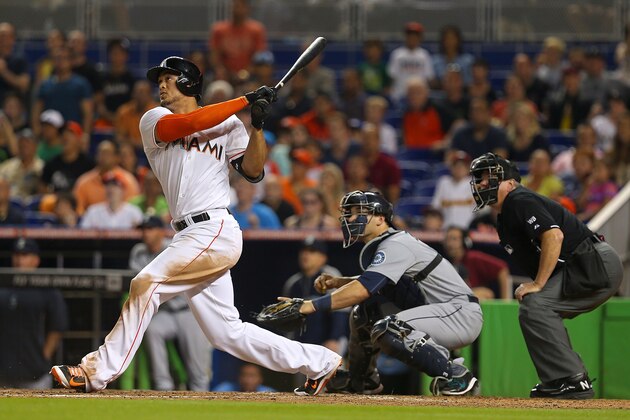 MIAMI, FL - APRIL 18:  Giancarlo Stanton #27 of the Miami Marlins  hits a walk off grand slam during a game against the Seattle Mariners at Marlins Park on April 18, 2014 in Miami, Florida.  (Photo by Mike Ehrmann/Getty Images)