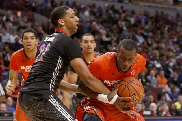 McDonald's West All-American Jahlil Okafor, left, fouls McDonald's East All-American Cliff Alexander during the second half of the McDonald's All-American boy's basketball game Wednesday, April 2, 2014, in Chicago . The West won 105-102. (AP Photo/Charles Rex Arbogast)