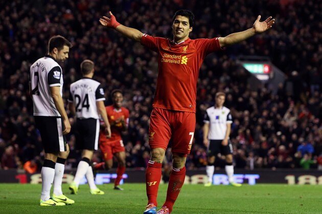 Liverpool's Luis Suarez, right, vies for the ball against Norwich City's Russell Martin during their English Premier League soccer match at Anfield, Liverpool, England, Saturday Oct. 22, 2011. (AP Photo/Tim Hales)