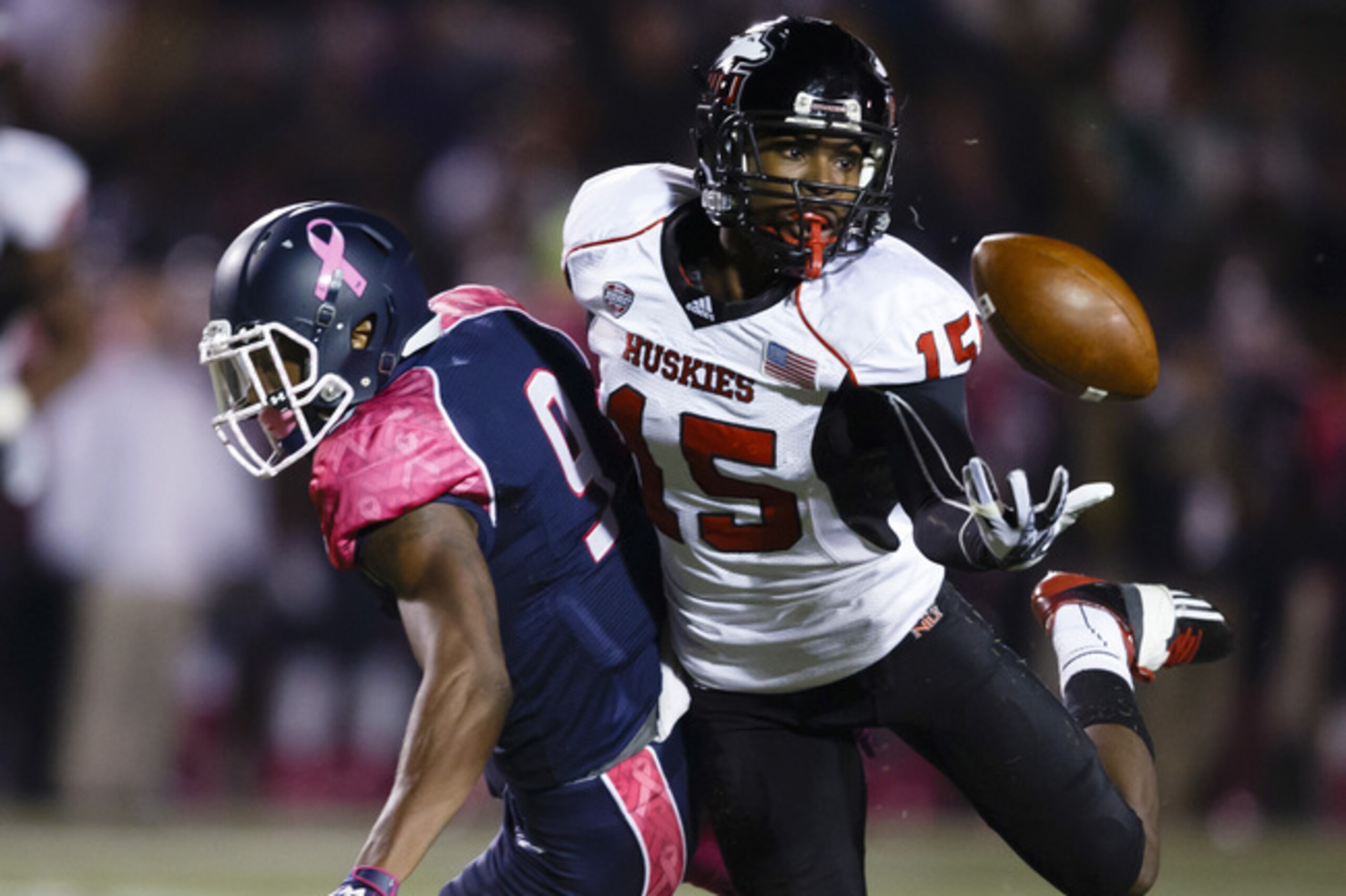 Northern Illinois safety Jimmie Ward (15) intercepts a pass intended for Toledo wide receiver Alonzo Russell (9) in the first quarter an NCAA college football game in Toledo, Ohio, Wednesday, Nov. 20, 2013. (AP Photo/Rick Osentoski)