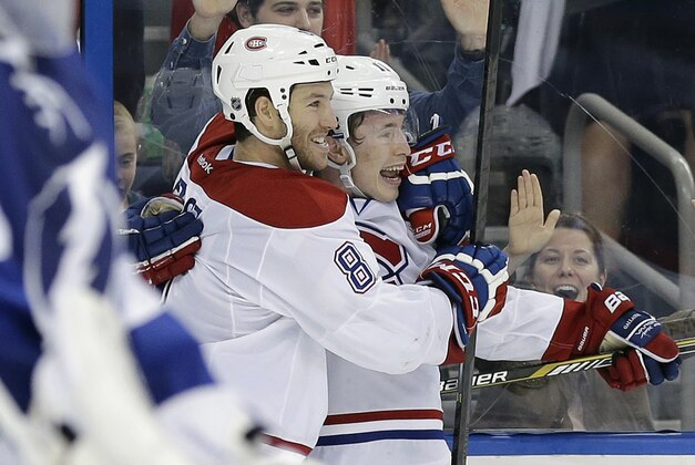 Montreal Canadiens right wing Brendan Gallagher, right, celebrates with right wing Brandon Prust after scoring against the Tampa Bay Lightning during the third period of Game 2 of a first-round NHL hockey playoff series on Friday, April 18, 2014, in Tampa, Fla. (AP Photo/Chris O'Meara)
