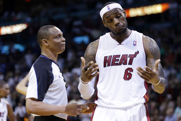 Miami Heat's LeBron James, right, reacts as he talks with official Michael Smith during the second half of an NBA basketball game against the Indiana Pacers, Friday, April 11, 2014, in Miami. The Heat defeated the Pacers 98-86. (AP Photo/Lynne Sladky)
