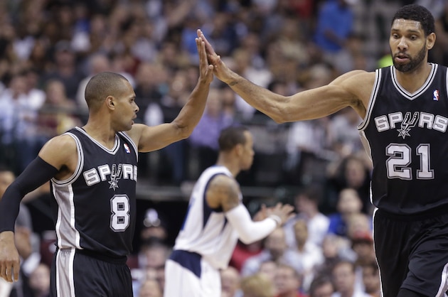 San Antonio Spurs guard Patty Mills (8) receives congratulations from Tim Duncan (21) during the second half an NBA basketball game against the Dallas Mavericks on Thursday, April 10, 2014, in Dallas. The Spurs won 109-100. (AP Photo/LM Otero)