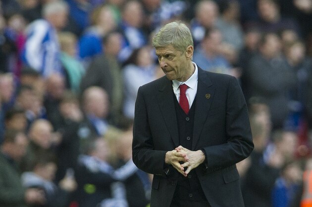 Arsenal's manager Arsene Wenger reacts, during their English FA Cup semifinal soccer match against Wigan Athletic, at the Wembley Stadium in London, Saturday, April 12, 2014. (AP Photo/Bogdan Maran)