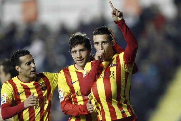 Barcelona's Cristian Tello, right, celebrates after scoring against Levante during their la Copa del Rey soccer match at the Ciutat de Valencia stadium in Valencia, Spain, Wednesday, Jan. 22, 2014. (AP Photo/Alberto Saiz)