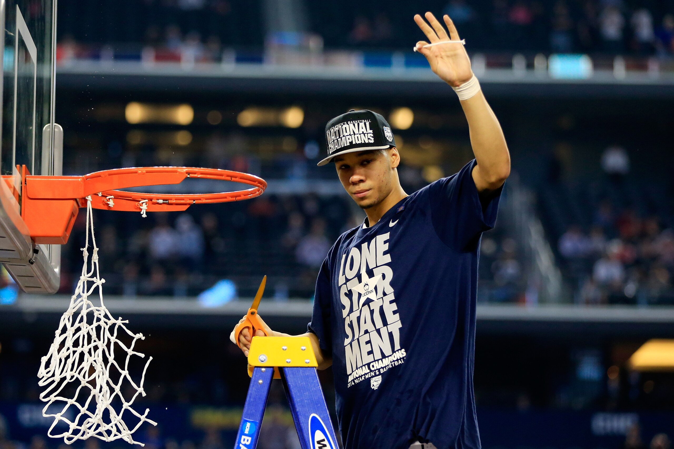 ARLINGTON, TX - APRIL 07: Shabazz Napier #13 of the Connecticut Huskies cuts down the net after defeating the Kentucky Wildcats 60-54 in the NCAA Men's Final Four Championship at AT&T Stadium on April 7, 2014 in Arlington, Texas.  (Photo by Jamie Squire/Getty Images)