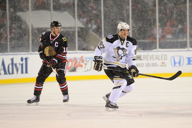 CHICAGO, IL - MARCH 01:  (EDITORIAL USE ONLY) Jonathan Toews #19 of the Chicago Blackhawks and Sidney Crosby #87 of the Pittsburgh Penguins skate through the neutral zone during the 2014 NHL Stadium Series game at Soldier Field on March 1, 2014 in Chicago, Illinois.  (Photo by Brian Babineau/NHLI via Getty Images)