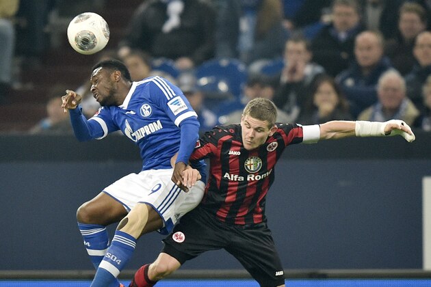 Schalke's Chinedu Obasi of Nigeria, left, and Frankfurt's Sebastian Jung challenge for the ball during the German Bundesliga soccer match between FC Schalke 04 and Eintracht Frankfurt in Gelsenkirchen, Germany, Friday April 11, 2014. (AP Photo/Martin Meissner)