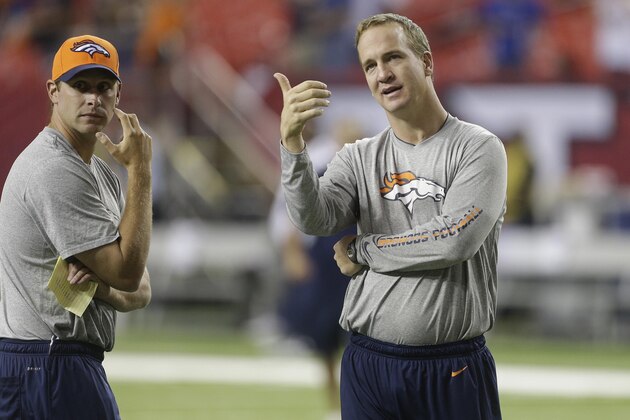 Denver Broncos quarterback Peyton Manning, right, speaks with quarterback coach Adam Gase before the first half of an NFL football game against the Atlanta Falcons, Monday, Sept. 17, 2012, in Atlanta. (AP Photo/John Bazemore)