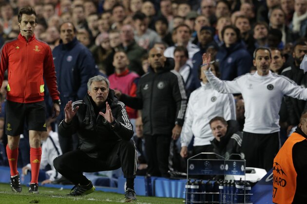 Chelsea's manager Jose Mourinho, on his knees as he watches the final moments of the match as Chelsea defeat Paris Saint-Germain in the Champions League quarterfinal second leg soccer match between Chelsea and Paris Saint Germain at Stamford Bridge stadium in London, Tuesday, April 8, 2014. Chelsea advance to the semifinals. (AP Photo/Matt Dunham).