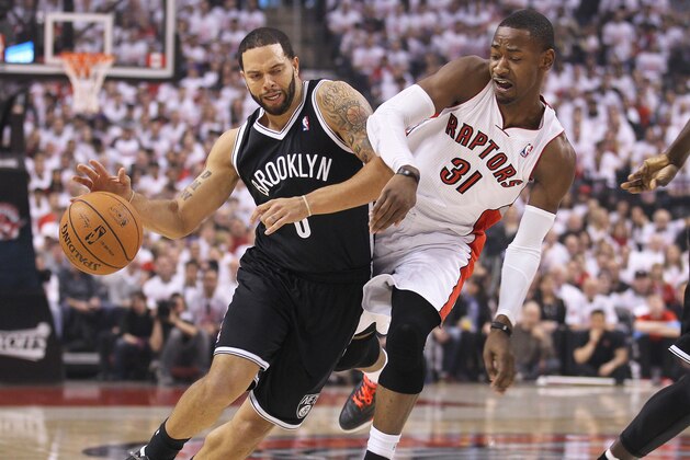 TORONTO, ON - APRIL 19:  Deron Williams #8 of the Brooklyn Nets plays against Terrence Ross #31 of the Toronto Rapters in Game One of the NBA Eastern Conference play-offs at the Air Canada Centre on April 19, 2014 in Toronto, Ontario, Canada. (Photo by Claus Andersen/Getty Images)