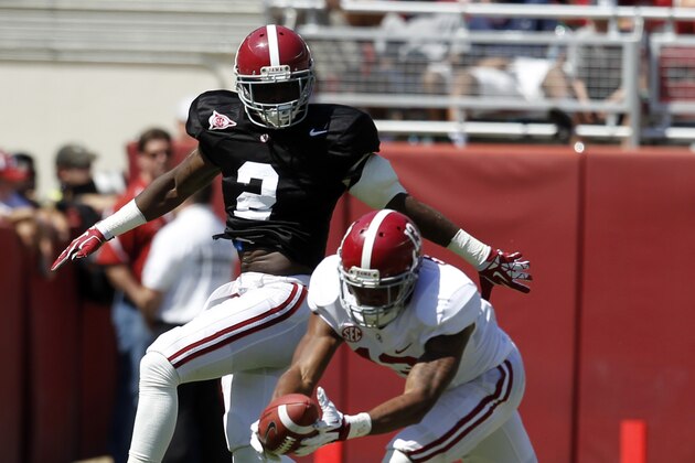 Wide receiver ArDarius Stewart (13) catches a deflected pass over defensive back Tony Brown (2) during Alabama's A-Day NCAA college football spring game on Saturday, April 19, 2014, in Tuscaloosa, Ala. (AP Photo/Butch Dill)
