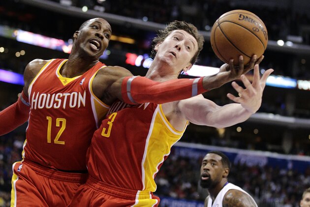 Houston Rockets' Dwight Howard, left, and Omer Asik, of Turkey, reach for a rebound during the first half of an NBA basketball game against the Los Angeles Clippers on Monday, Nov. 4, 2013, in Los Angeles. The Clippers won 137-118. (AP Photo/Jae C. Hong)