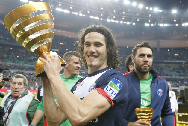 Paris Saint Germain's Edinson Cavani of Argentina, center, and goalkeeper Salvatore Sirigu, right, pose with the trophy after winning the French League Cup Final soccer match against Lyon at the Stade de France in Saint Denis, north of Paris, Saturday April 19, 2014. (AP Photo/Jacques Brinon)