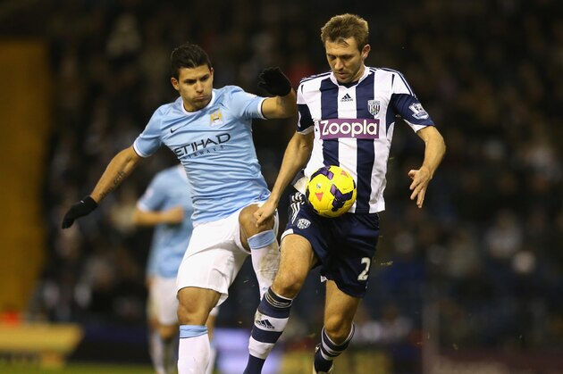 WEST BROMWICH, ENGLAND - DECEMBER 04:  Gareth McAuley of West Bromwich is challenged by Sergio Aguero during the Premier League match between West Bromwich Albion and Manchester City at The Hawthorns on December 4, 2013 in West Bromwich, England.  (Photo by David Rogers/Getty Images)