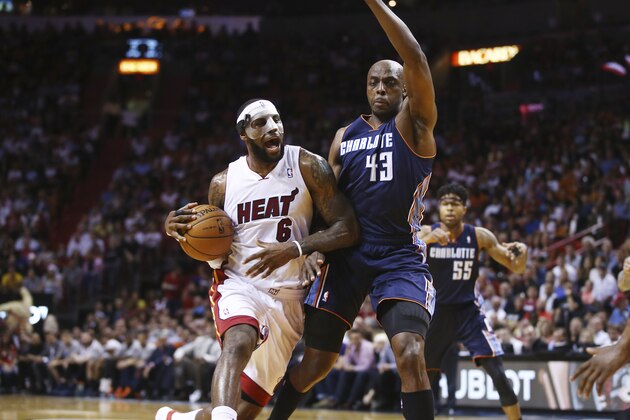 Miami Heat's Ray Allen (34) tries to steal the ball from Charlotte Bobcats' Anthony Tolliver (43) during the second half of an NBA basketball game in Miami, Monday, March 3, 2014. LeBron James scored a team record of 61 points. The Heat won 124-107. (AP Photo/J Pat Carter)