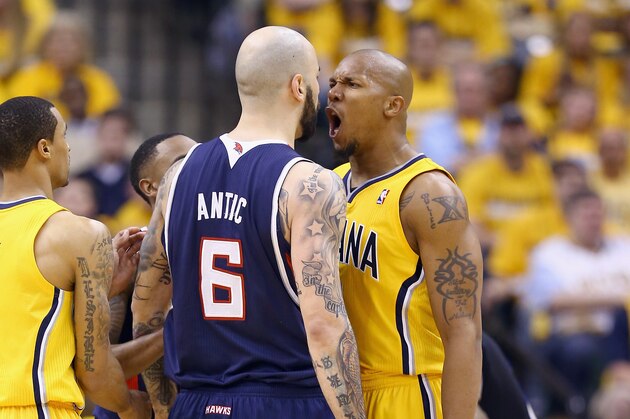 INDIANAPOLIS, IN - APRIL 19:  Pero Antic #6 of the Atllanta Hawks and David West #21 of the Indiana Pacers square off in Game 1 of the Eastern Conference Quarterfinals during the 2014 NBA Playoffs at Bankers Life Fieldhouse on April 19, 2014 in Indianapolis, Indiana. NOTE TO USER: User expressly acknowledges and agrees that, by downloading and or using this photograph, User is consenting to the terms and conditions of the Getty Images License Agreement.  (Photo by Andy Lyons/Getty Images)