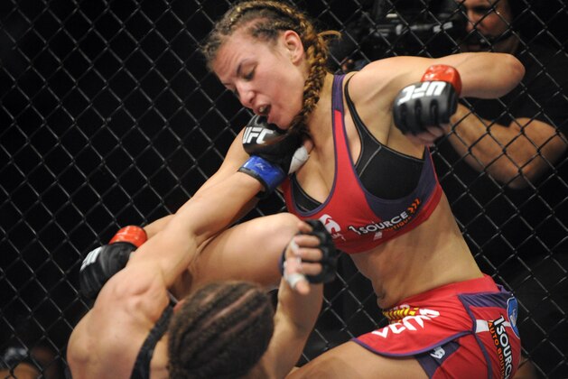 Apr 19, 2014; Orlando, FL, USA; (Editors note: Caption correction) Miesha Tate (red gloves) fights Liz Carmouche (blue gloves) in their women's bantamweight fight during UFC on FOX 11 at Amway Center. Mandatory Credit: David Manning-USA TODAY Sports
