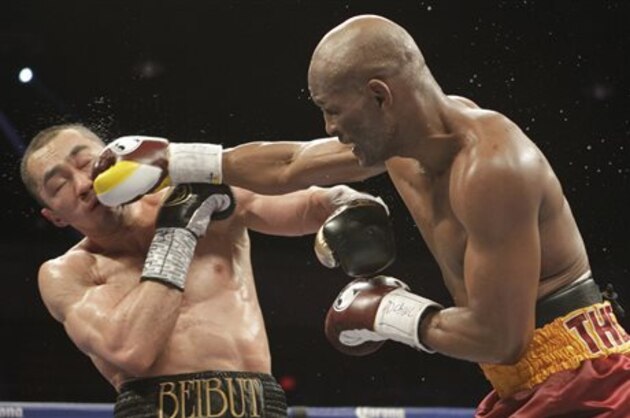 Beibut Shumenov, left, of Kazakhstan, takes a punch from Bernard Hopkins, right, of the United States, during their IBF, WBA and IBA Light Heavyweight World Championship unification boxing match, Saturday, April 19, 2014, in Washington. Hopkins won by a split decision. (AP Photo/Luis M. Alvarez)