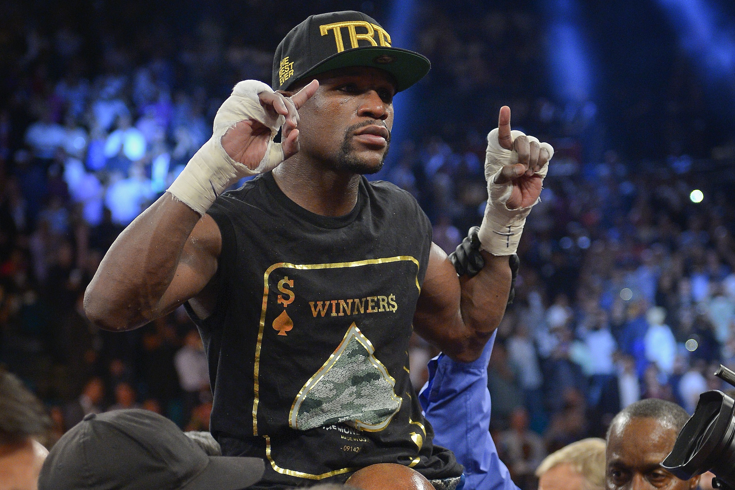 Floyd Mayweather Jr. celebrates after defeating Canelo Alvarez during a 152-pound title fight, Saturday, Sept. 14, 2013, in Las Vegas. (AP Photo/Mark J. Terrill)