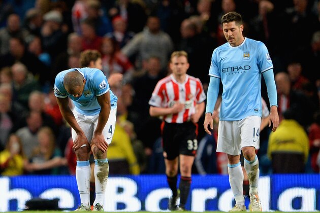 MANCHESTER, ENGLAND - APRIL 16:  A dejected Vincent Kompany and Javi Garcia of Manchester City during the Barclays Premier League match between Manchester City and Sunderland at Etihad Stadium on April 16, 2014 in Manchester, England.  (Photo by Michael Regan/Getty Images)