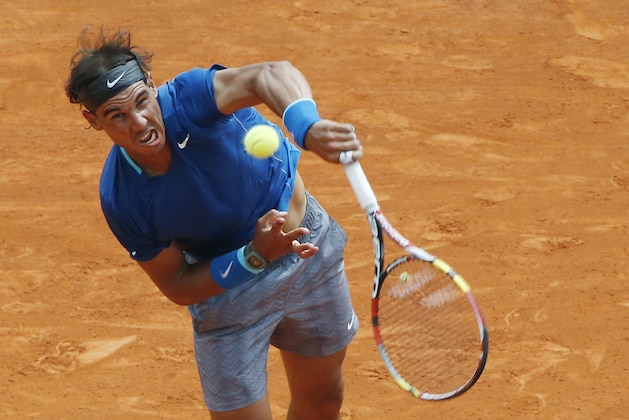 Rafael Nadal of Spain serves the ball to David Ferrer of Spain during their quarterfinals match of the Monte Carlo Tennis Masters tournament in Monaco, Friday, April 18, 2014. Ferrer won 7-6 6-4. (AP Photo/Michel Euler)