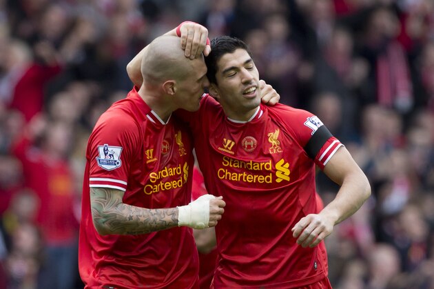 Liverpool's Martin Skrtel, left, celebrates with teammate Luis Suarez after their team beats Manchester City 3-2 in their English Premier League soccer match at Anfield Stadium, Liverpool, England, Sunday April 13, 2014. (AP Photo/Jon Super)